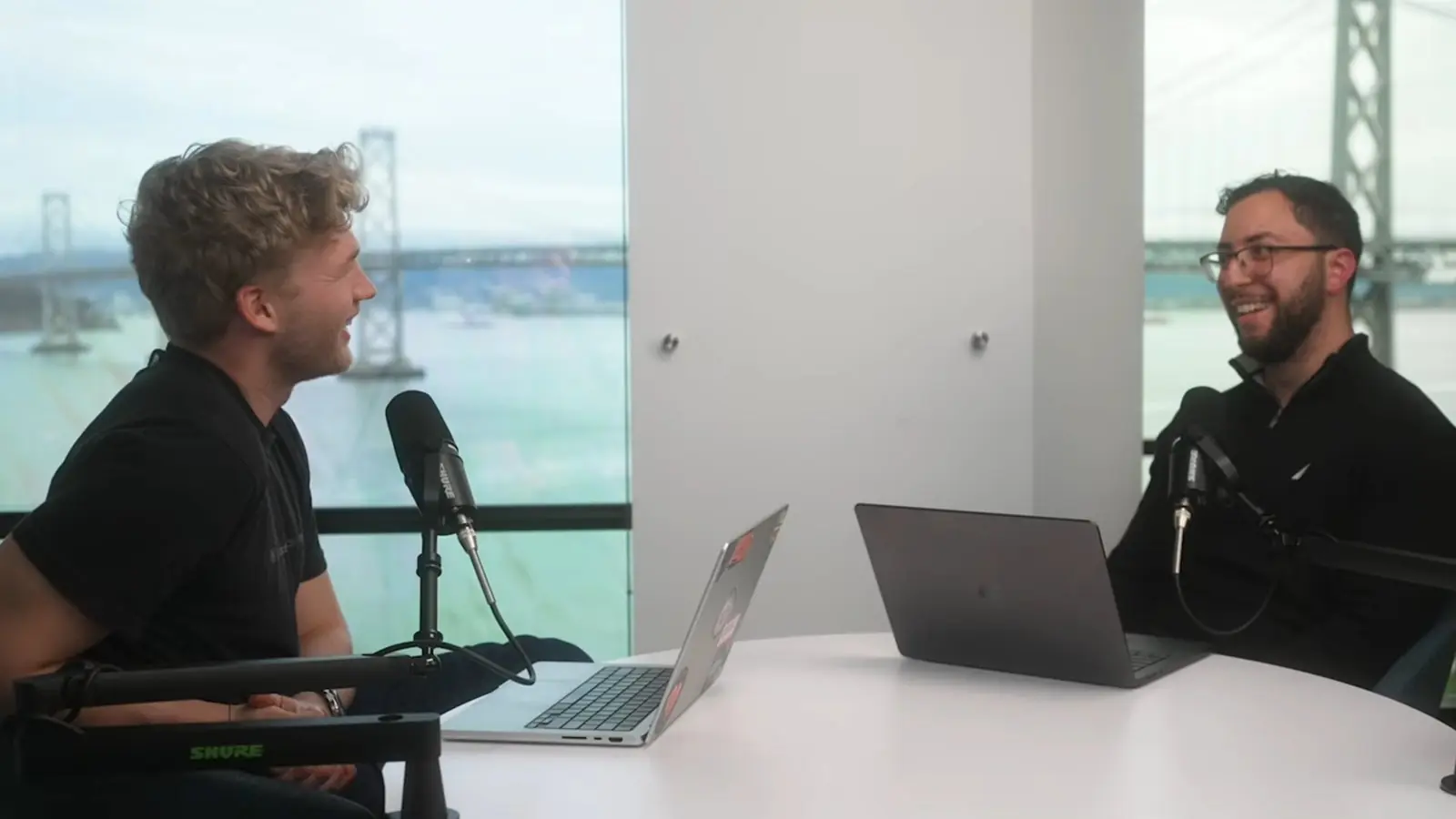Erfan Al-Hossami (right) in a podcast interview overlooking the Bay Bridge