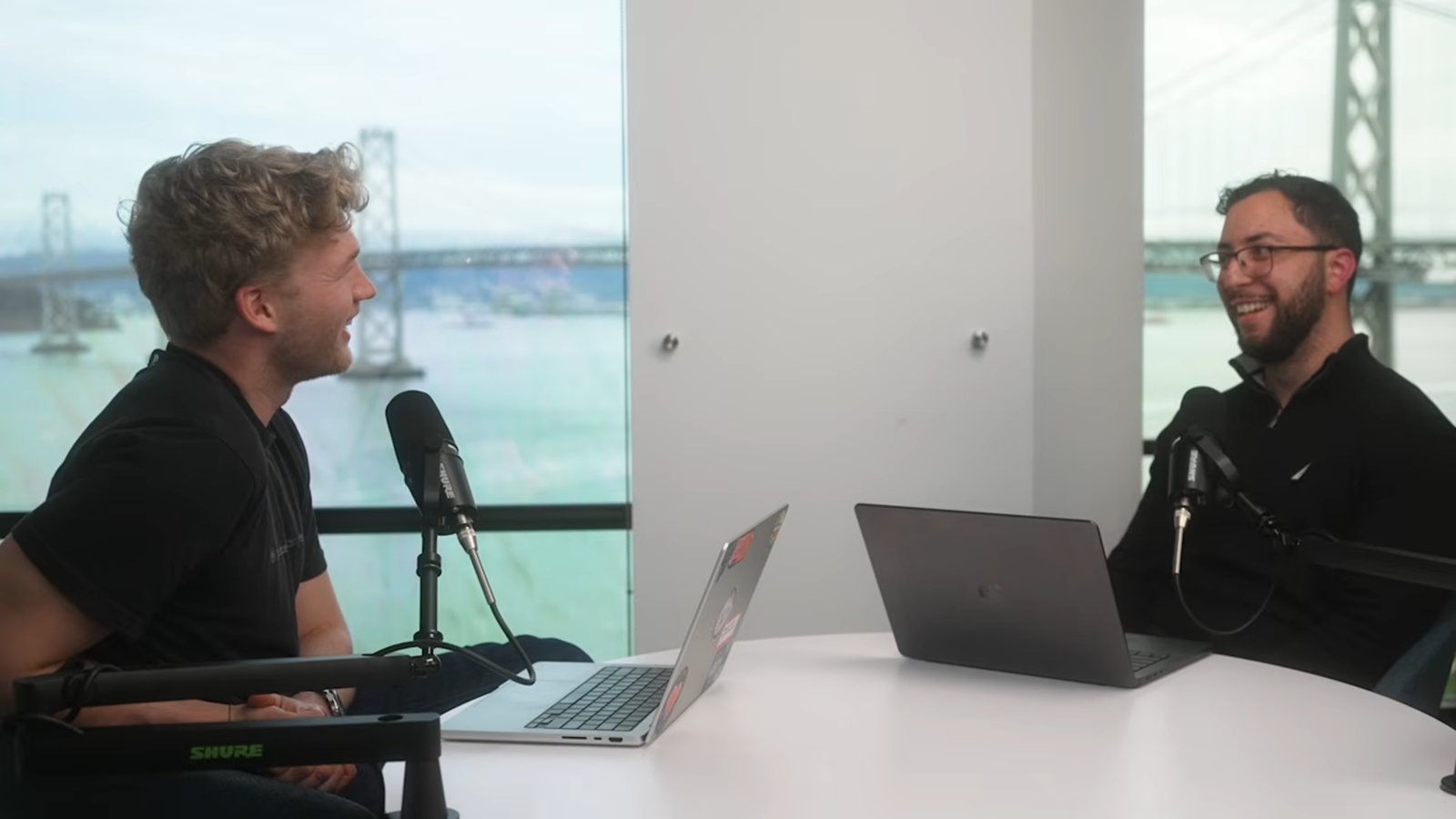 Erfan Al-Hossami (right) in a podcast interview overlooking the Bay Bridge